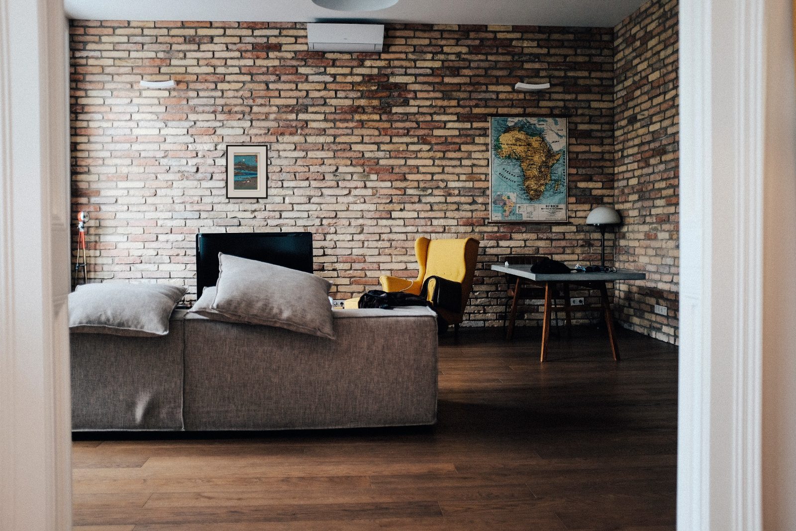 A small 24 by 36 cm print on a wide brick wall - lost on it