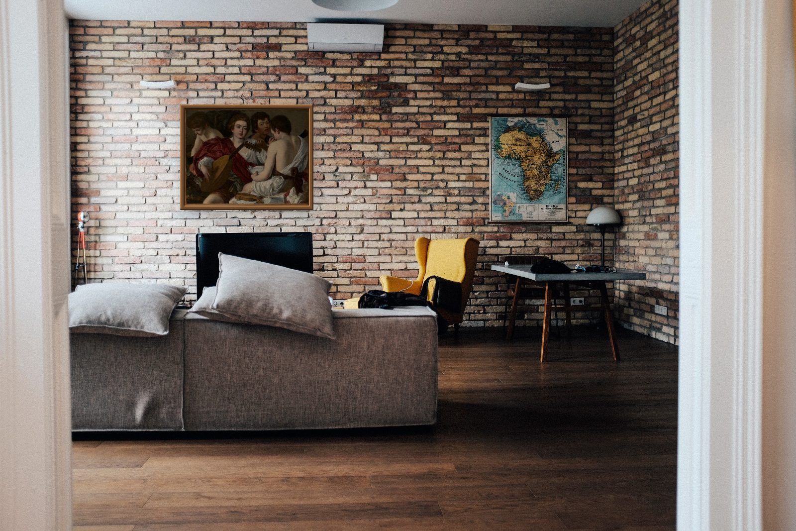 Caravaggio, The Musicians, 118 by 92 cm, rendered on a brick wall in a real apartment